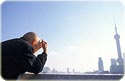 image of an old man looking toward Shanghai\'s ֶ Pudong skyline